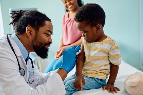 photo of doctor giving vaccine to child