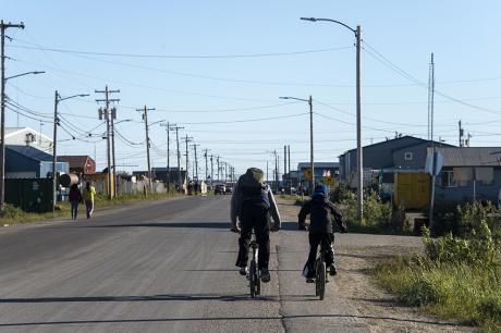 photo of two cyclists riding together on a big road