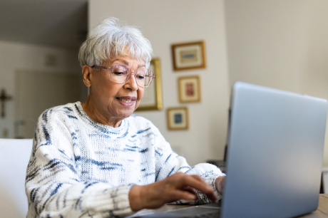 photo of woman using a laptop computer at home