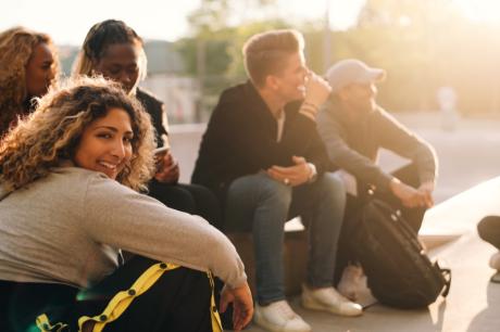High school students sit together outdoors.
