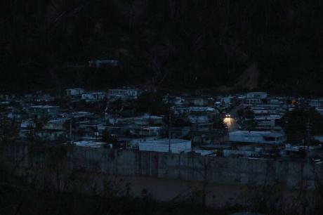 UTUADO, PUERTO RICO - OCTOBER 06: A car passes among dark homes as people wait for electricity to be restored after Hurricane Maria passed through on October 6, 2017 in Utuado, Puerto Rico. Puerto Rico experienced widespread damage including most of the electrical, gas and water grid as well as agriculture after Hurricane Maria, a category 4 hurricane, passed through. 