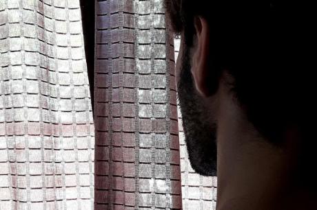 photo of man looking out window