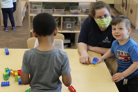 Daycare teacher plays with kids during COVID-19