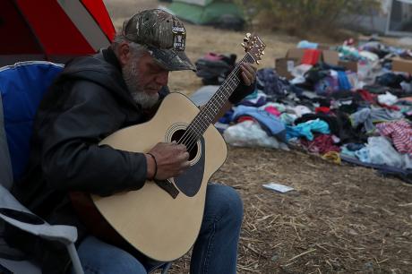Man who was displaced during Camp Fire plays guitar