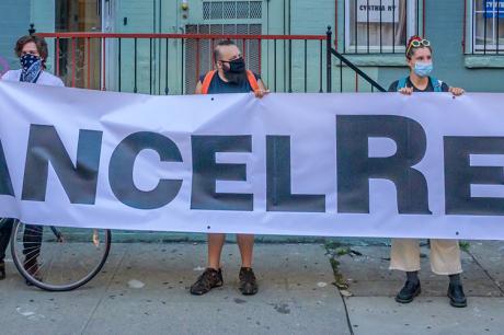 Protesters hold "cancel rent" sign
