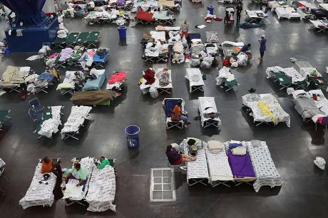 Hurricane evacuees shelter in a convention center