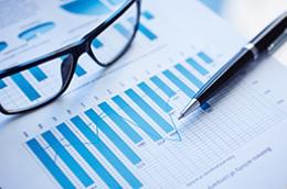 glasses, pen, and analysis paperwork