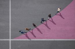 Businesspeople walking on painted up going graph, on asphalt
