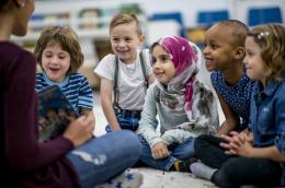 Teacher reading books to children