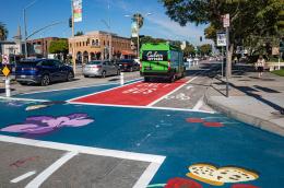 photo of pedestrian, traffic, bus, and bicycle lanes in downtown area to reduce congestion and emissions