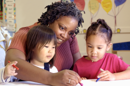 photo of teacher coloring with girls