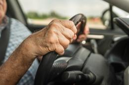 photo of hands driving on steering wheel