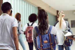 Students walking down a hallway. 