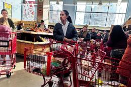 People waiting in line to check out at a grocery store.