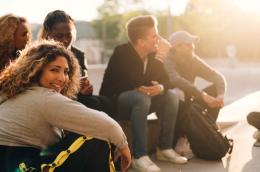 High school students sit together outdoors.