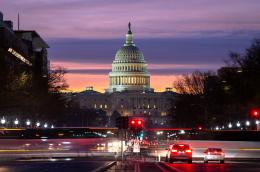 The US capitol and traffic at sunset.