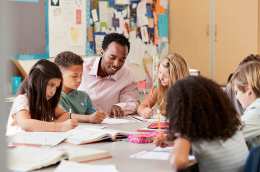photo of students in classroom with teacher