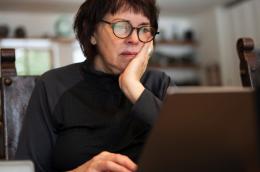 photo of person looking at laptop