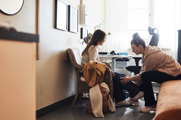 stock photo of physiotherapist examining leg of female student in school office