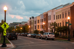 Quiet residential street with modern townhomes at dusk.