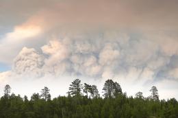 A plumes of smoke from the Camp Fire hangs in the air on Moose Lake as multiple wildfires burning in the Boundary Waters Canoe Area Wilderness prompted its closure and evacuation Tuesday, July 14, 2026 in Ely, Minnesota
