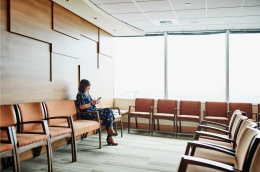 A young woman sitting in a waiting room.
