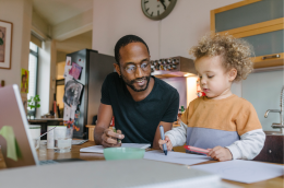 A father and son drawing together.
