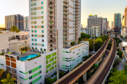 Tracks for a public train system surrounded by apartments in Miami, Florida. 