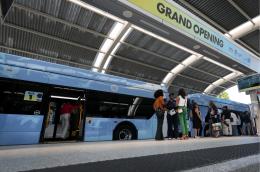 people gathering at a bus rapid transit (BRT) station for the launch of Metro Express, Miami-Dade County’s first-ever BRT system