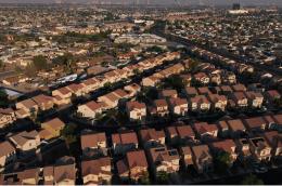 Aerial view of a suburban neighborhood with rows of single-family homes.