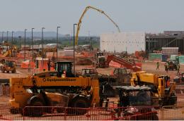 Construction site with heavy equipment and workers.