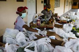 Volunteers pack groceries during the COVID-19 pandemic