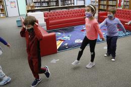 Kindergarten students practice social distance walking through the library at Lupine Hill Elementary School in Calabasas, CA