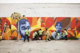 Volunteers painting wall together