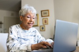 photo of woman using a laptop computer at home