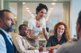 A group of professionals working together in a conference room. 